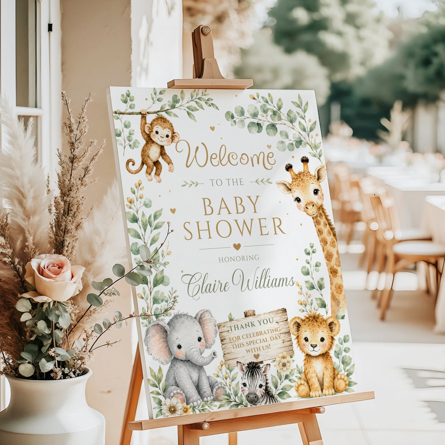 Editable safari baby shower welcome sign Canva template with watercolour monkey, giraffe, elephant, lion cub, and zebra surrounded by eucalyptus and tropical leaves with gold accents on a white background