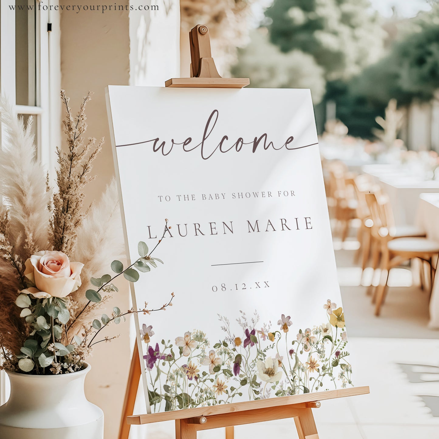 Vertical wildflower baby shower welcome sign template with watercolor meadow flowers in yellow, purple, and cream, editable in Canva