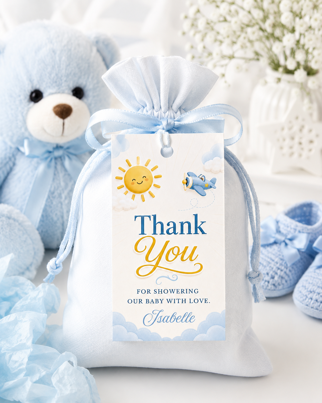 Editable here comes the son baby shower favor hang tag Canva template with smiling sun, blue toy airplane, fluffy clouds, and bold navy and golden script typography on a warm cream background