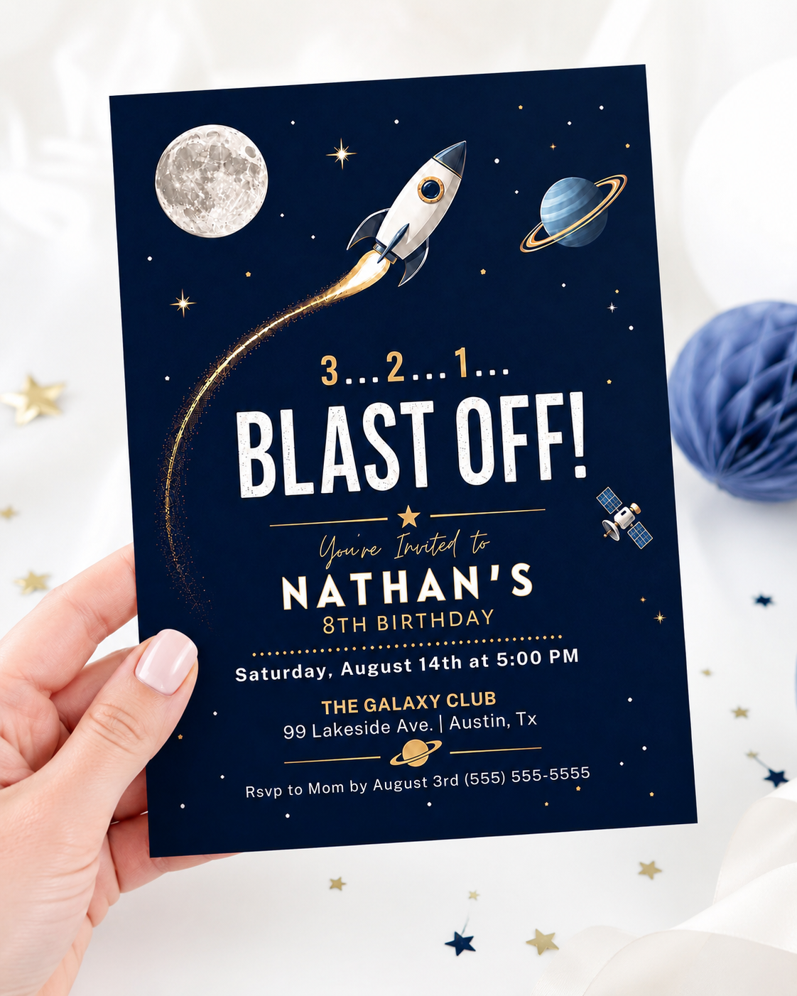Rocket ship birthday party invitation with a rocket, moon, and planet on a navy and gold space background