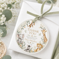 Editable safari baby shower round thank you sticker Canva template with watercolour monkey, giraffe, elephant, lion cub, and zebra in a eucalyptus and tropical leaf wreath on a cream background