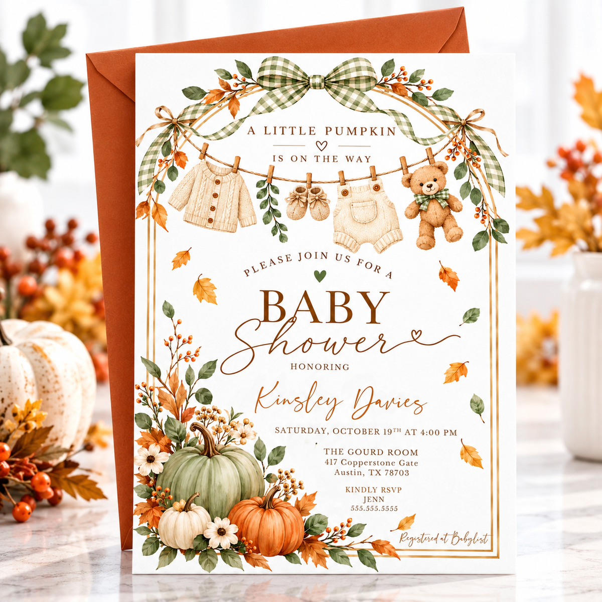 Little Pumpkin baby shower invitation with sage green and orange pumpkins, gingham bows, fall leaves, teddy bear, and knitted baby clothes on a clothesline