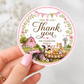 Round barnyard birthday thank-you sticker featuring a pink tractor, barn, cow, pig, pony, chick, puppy, kitten, flowers and pastel bunting.