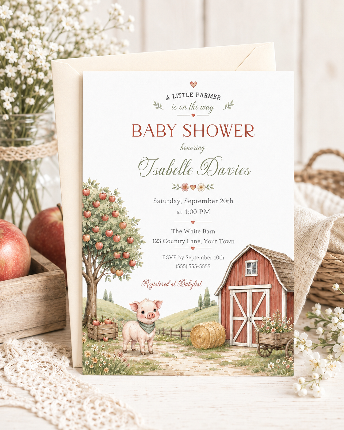 Little farm baby shower invitation with red barn, apple tree, piglet, hay bale, flower cart, rolling hills, fence, wildflowers, and soft farmhouse details