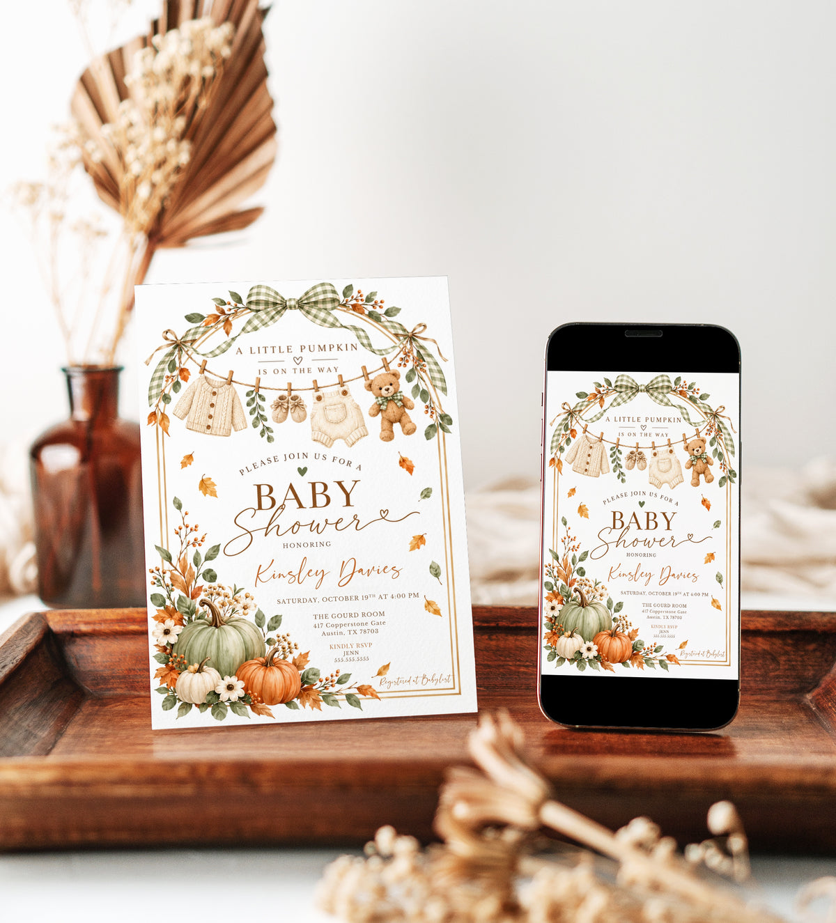 Little Pumpkin baby shower invitation with sage green and orange pumpkins, gingham bows, fall leaves, teddy bear, and knitted baby clothes on a clothesline