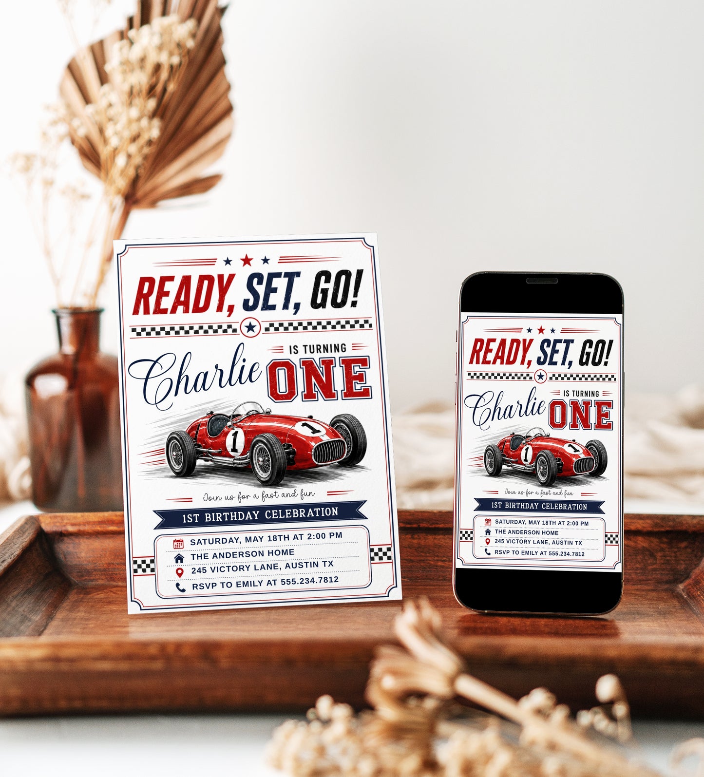 Race car first birthday invitation with red vintage race car, checkered flags, varsity ONE lettering, racing stripes, stars, and bold boys 1st birthday details