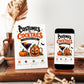 Costumes and Cocktails Halloween invitation with purple cocktail, jack-o-lantern copper mug, pumpkin, orange slices, bats, greenery, and adult Halloween party details
