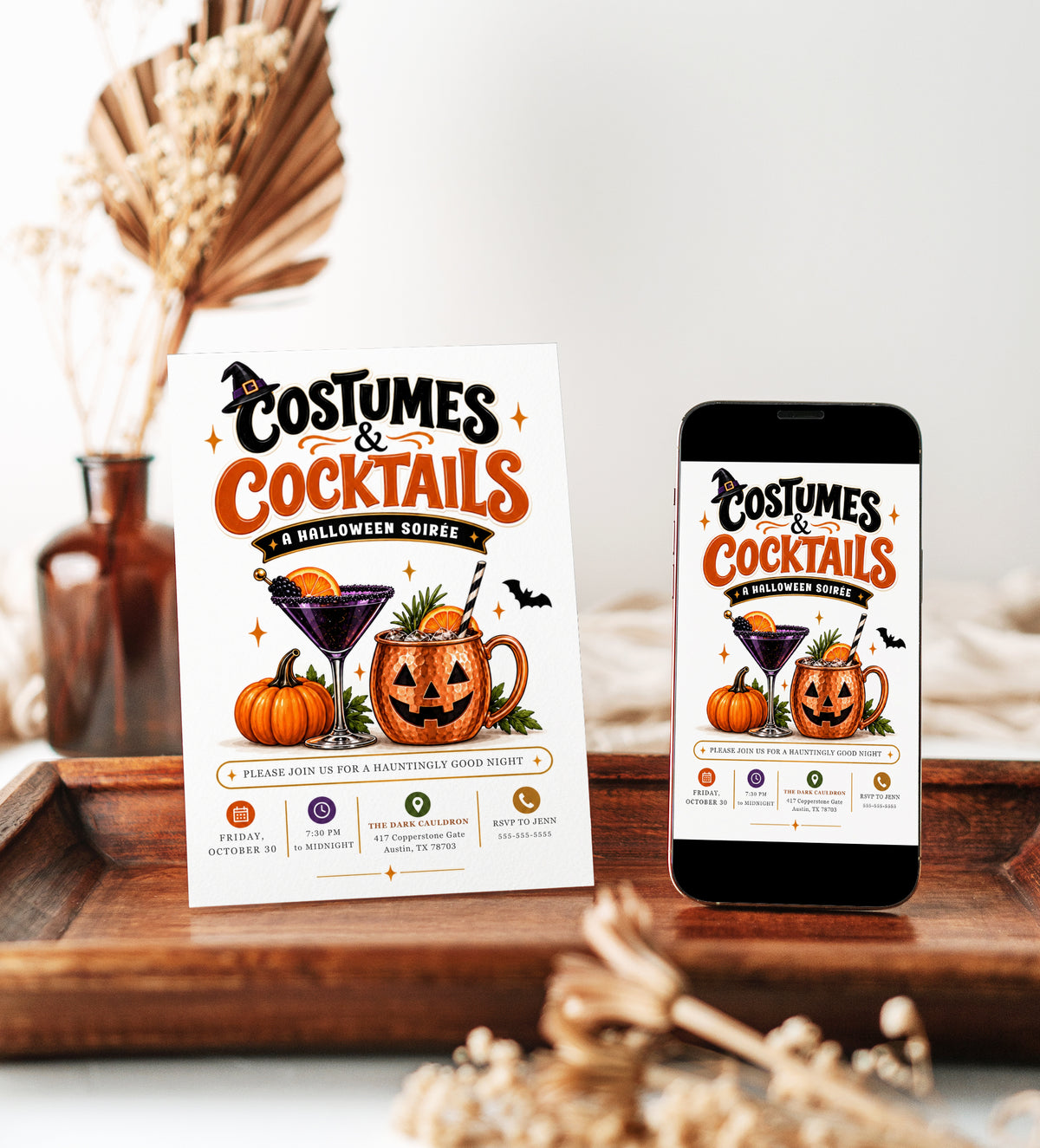Costumes and Cocktails Halloween invitation with purple cocktail, jack-o-lantern copper mug, pumpkin, orange slices, bats, greenery, and adult Halloween party details