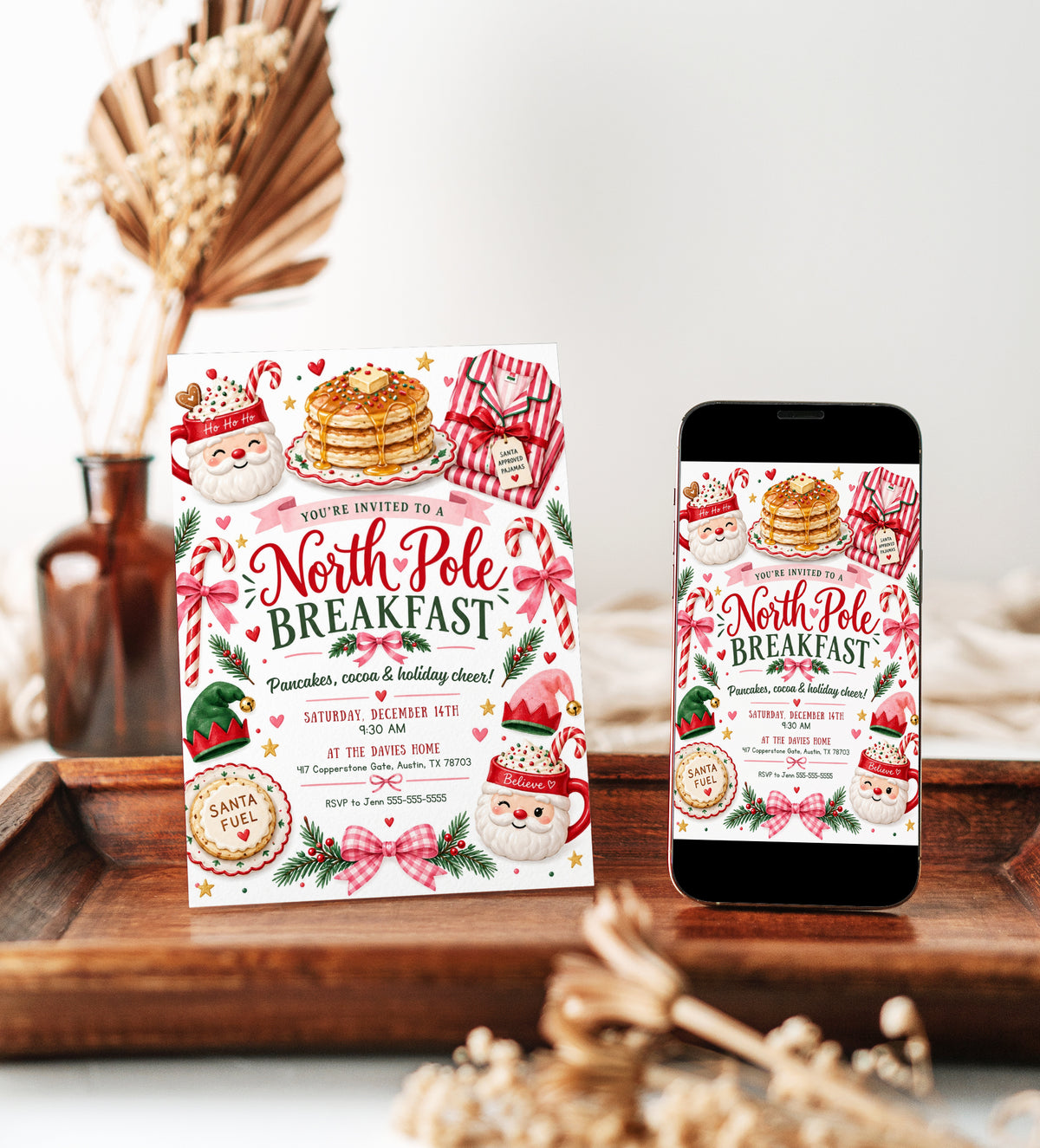North Pole Breakfast invitation with Santa mugs, stacked pancakes, candy canes, Christmas pajamas, elf hats, pink bows, evergreen sprigs, and festive holiday party details