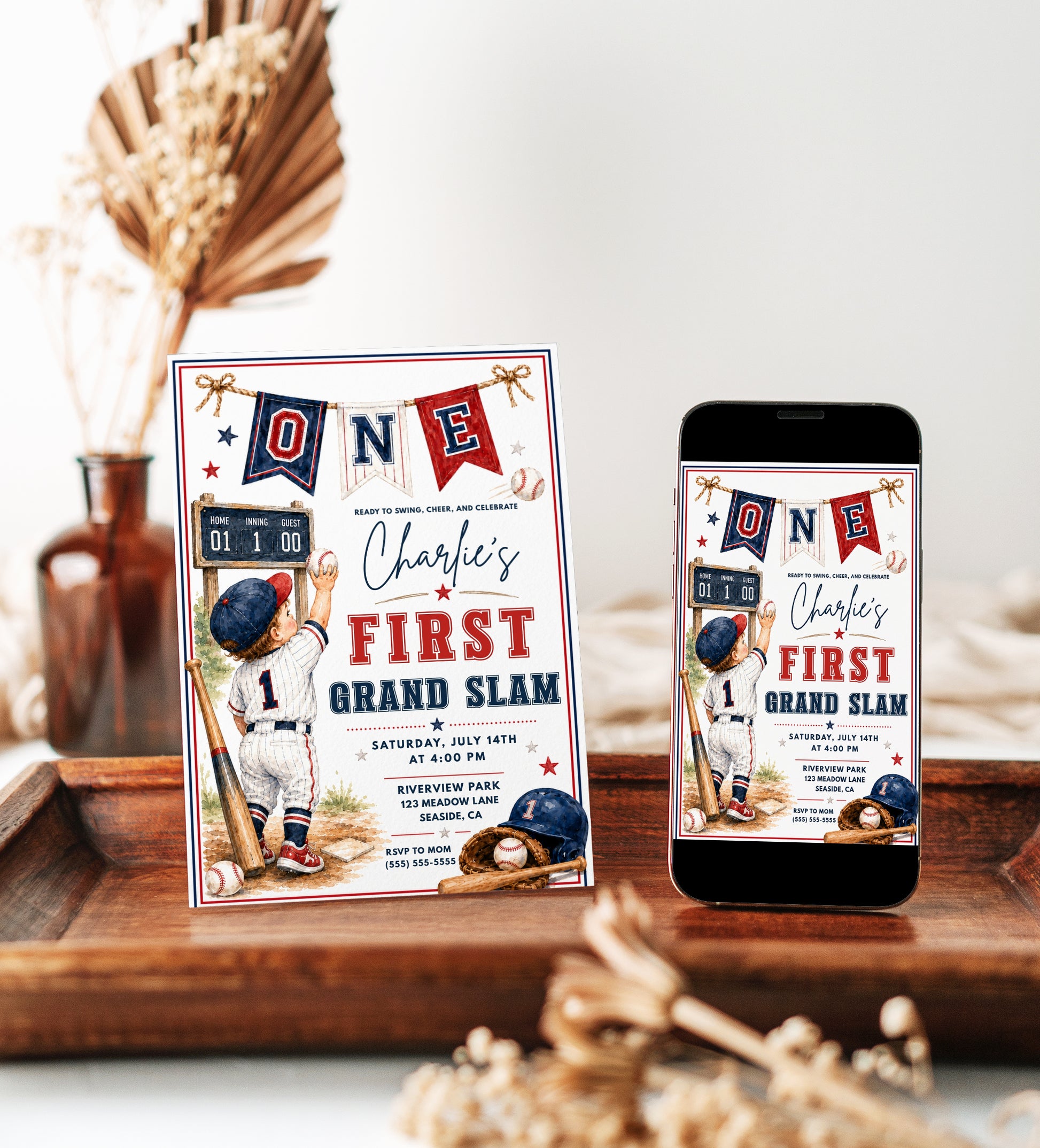 Baseball first birthday invitation featuring a little boy in a baseball uniform, ONE banner, scoreboard, bat, glove, helmet and red and navy details.
