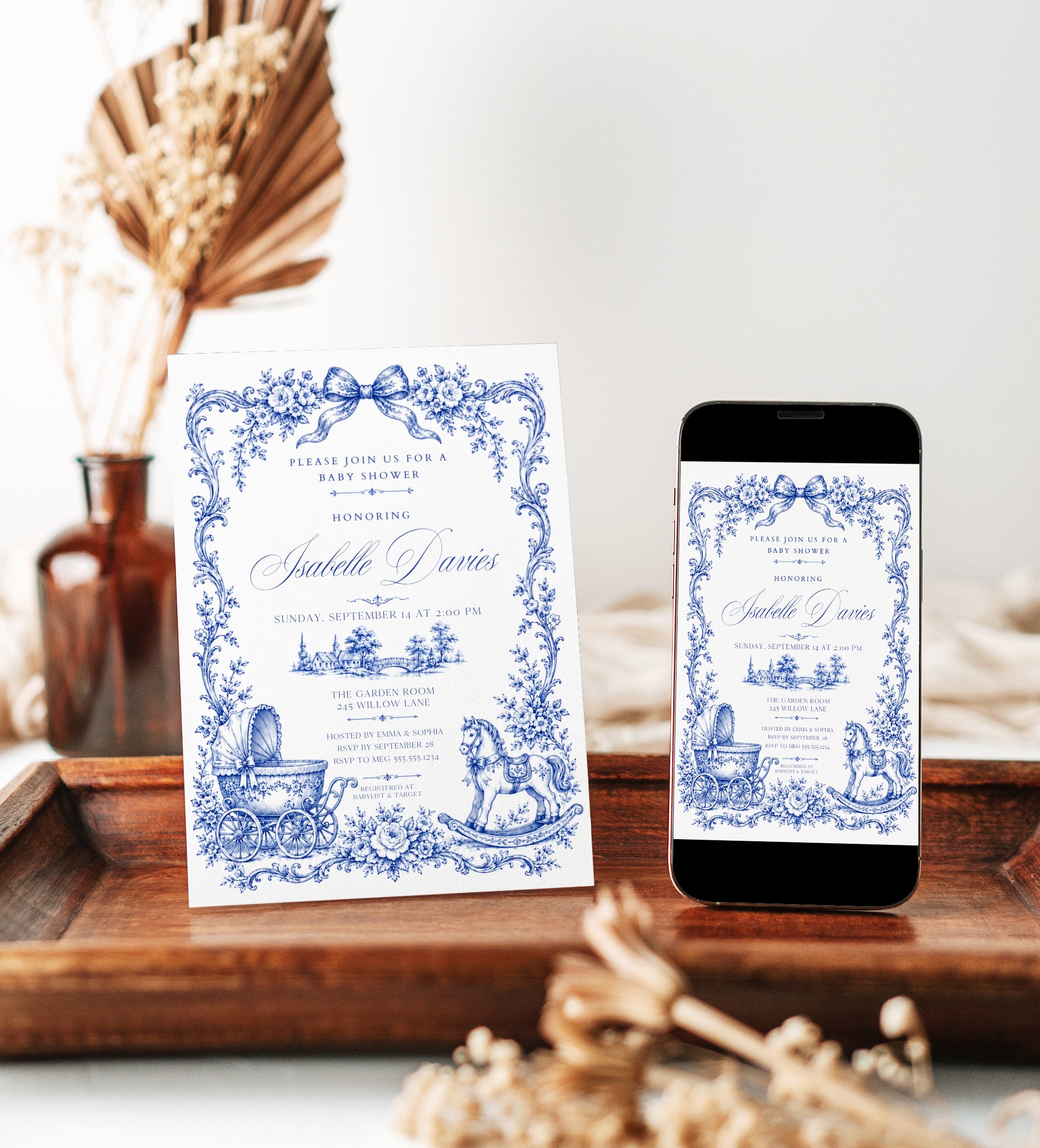 Blue toile baby shower invitation with royal blue floral border, bow, baby carriage, rocking horse, countryside scene, and elegant vintage details