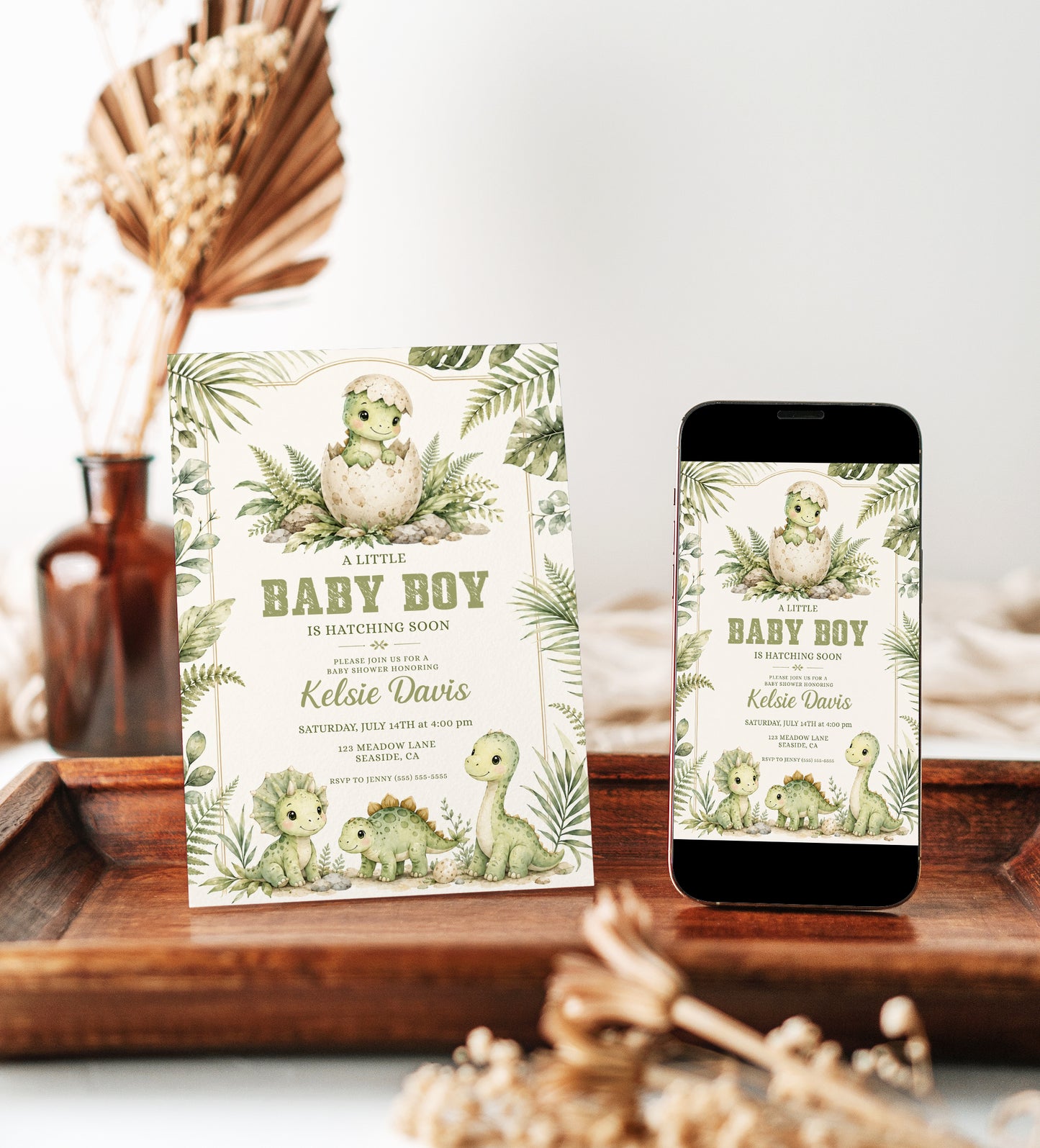 Baby boy dinosaur baby shower invitation with watercolor baby dinosaurs, hatching egg, tropical leaves, ferns, greenery, rocks, and soft sage green details