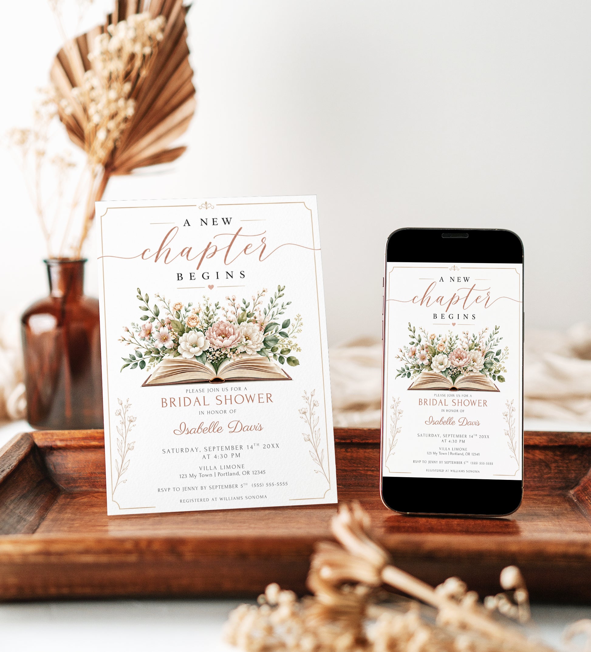A New Chapter bridal shower invitation featuring an open book surrounded by blush pink and terracotta florals with green foliage.
