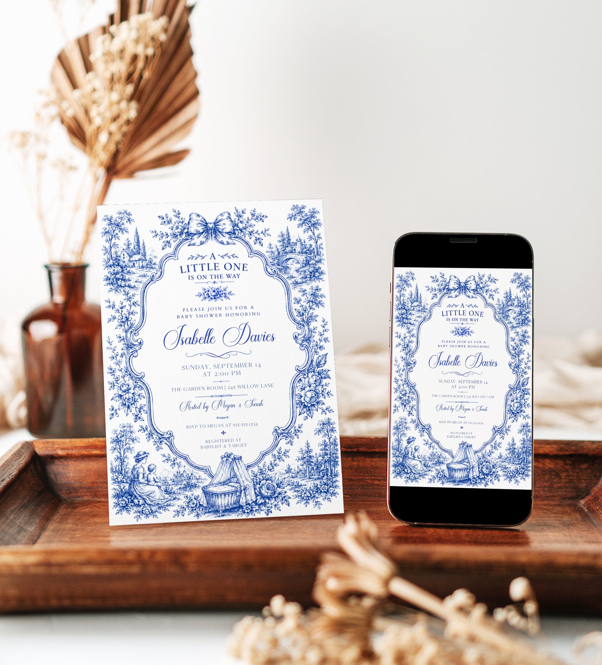 Blue toile baby shower invitation with ornate floral frame, bow, baby carriage, rocking horse, countryside scene, and elegant royal blue vintage details
