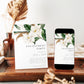 Editable white magnolia engagement party invitation Canva template with oversized watercolour magnolia blooms, deep green leaves, and bold spaced serif typography on a white background