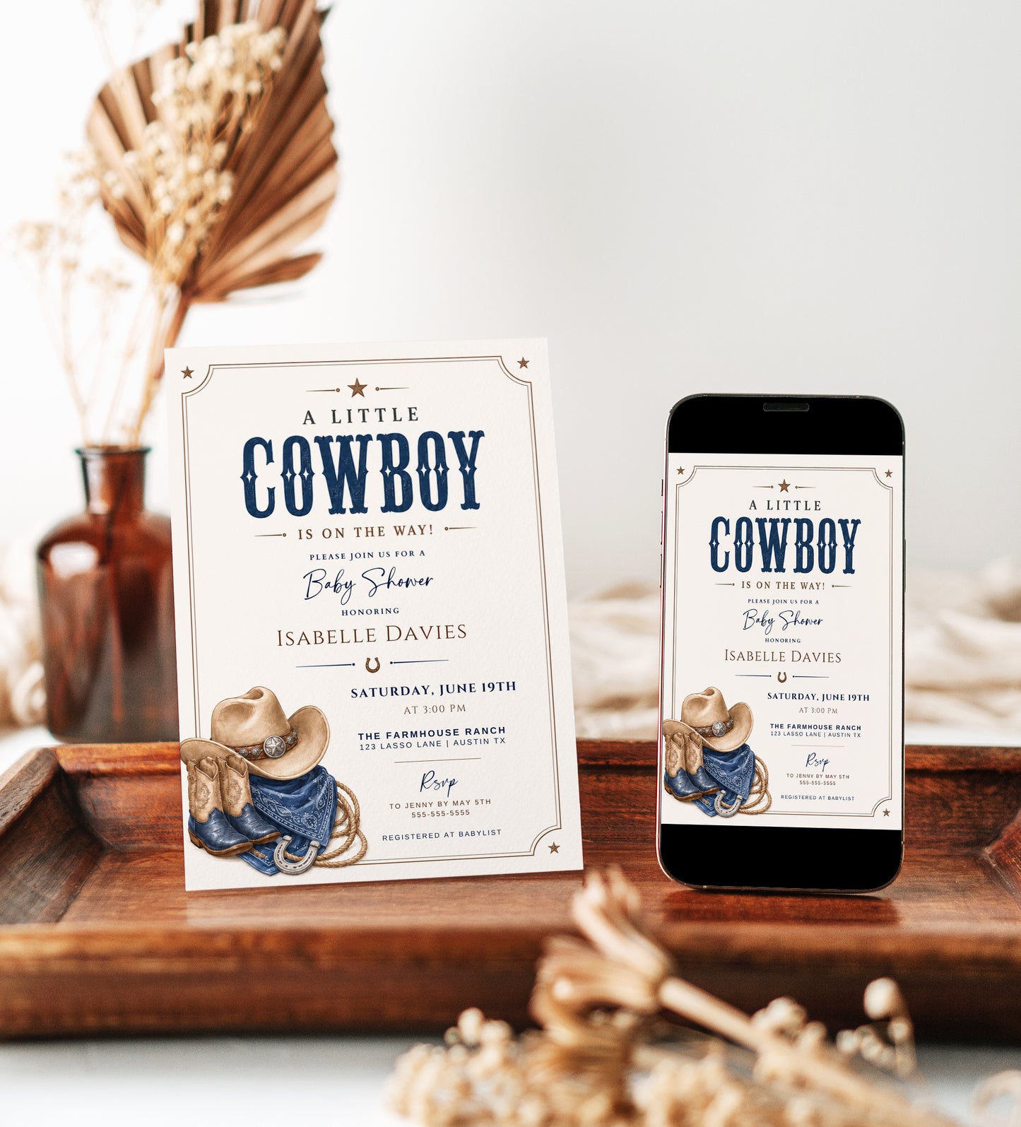 Editable Western cowboy baby shower invitation Canva template with illustrated cowboy hat, denim boots, horseshoe, bandana, lasso rope, and bold navy distressed typography on a warm cream background with Western border