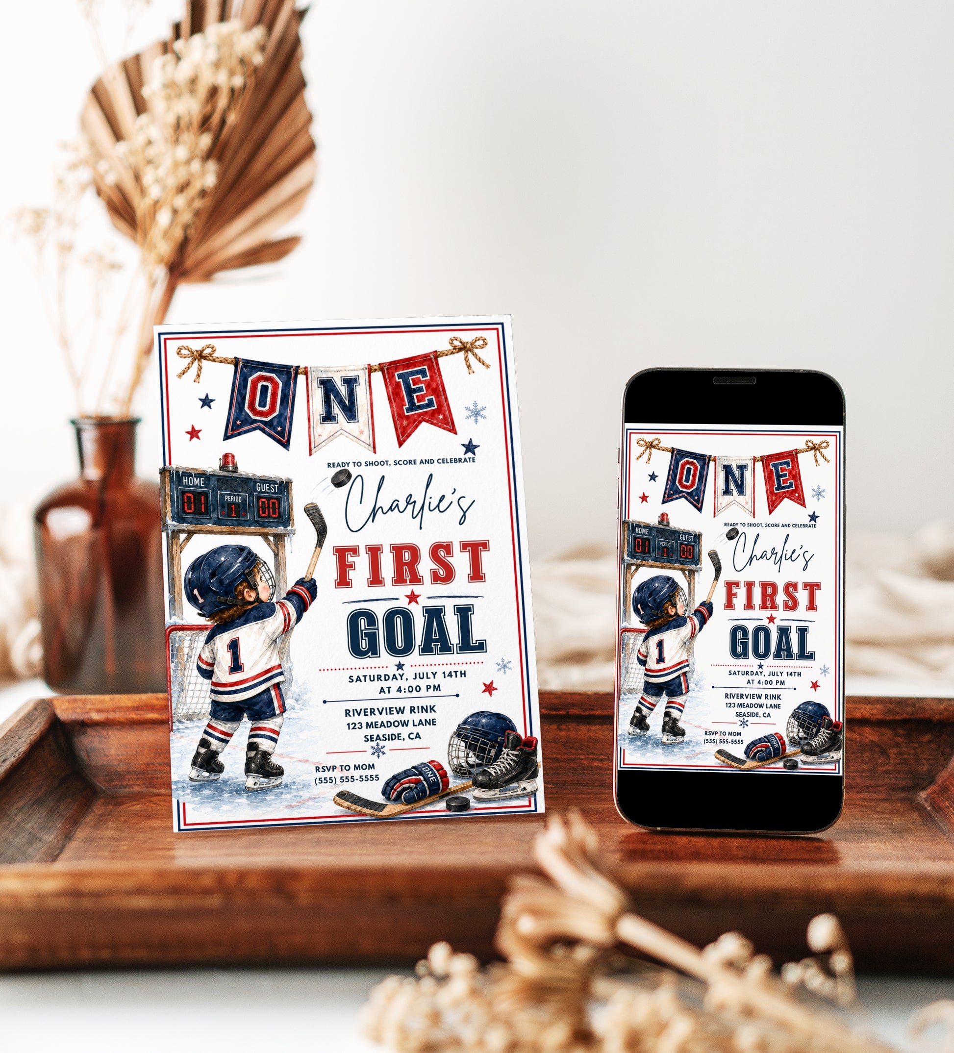 Hockey first birthday invitation with toddler hockey player, goal net, scoreboard, skates, puck, stick, helmet, gloves, snowflakes, and red navy sports details