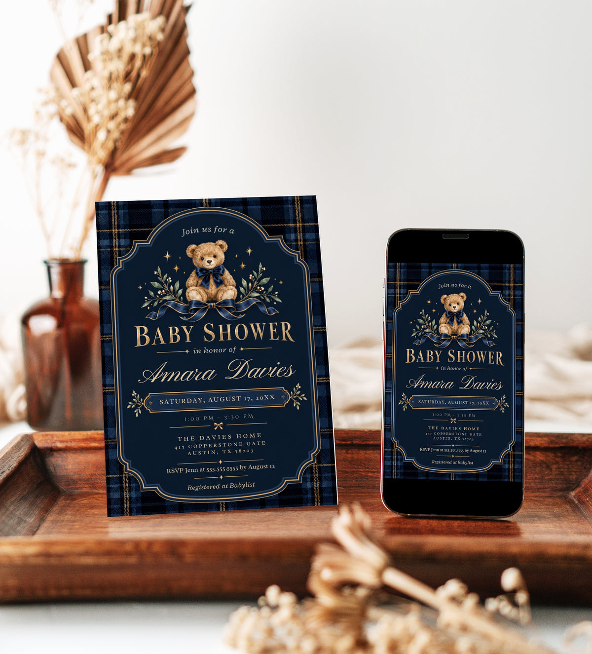 Teddy bear baby shower invitation with a brown bear wearing a navy bow, blue plaid border, gold lettering, stars, and greenery on a dark navy background