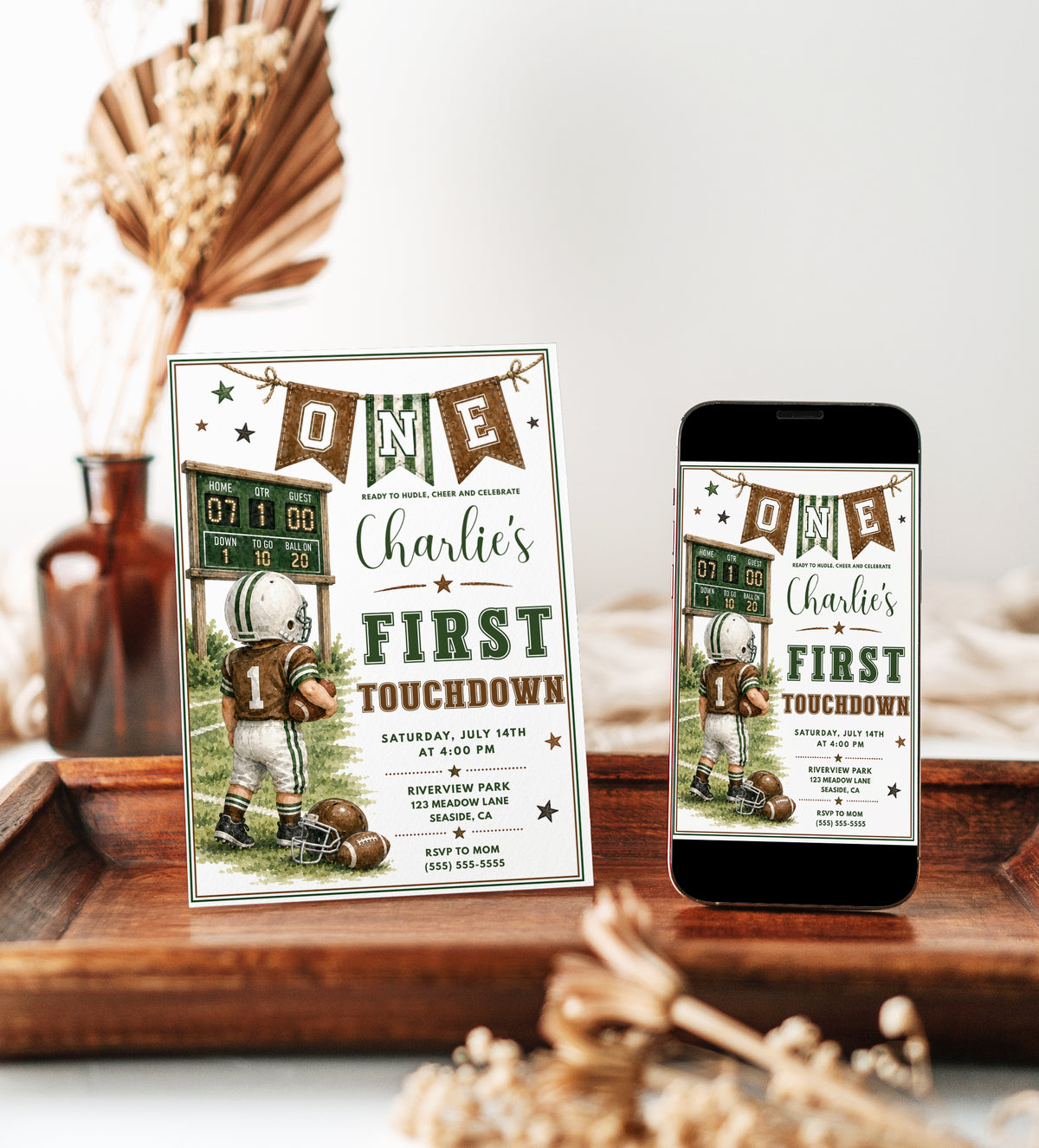 Football first birthday invitation with toddler football player, scoreboard, helmet, footballs, pennant banner, stars, field details, and green brown varsity style