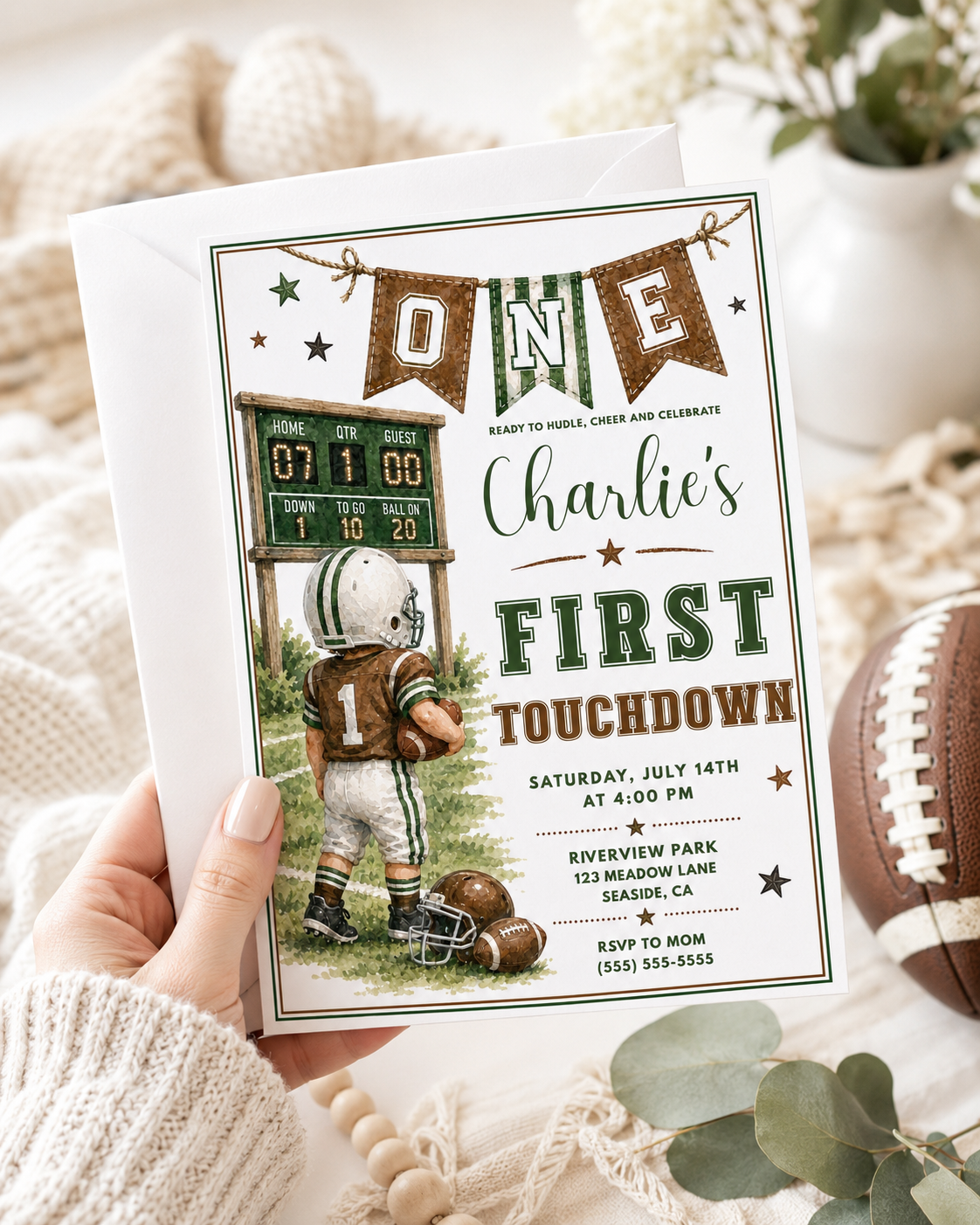 Football first birthday invitation with toddler football player, scoreboard, helmet, footballs, pennant banner, stars, field details, and green brown varsity style