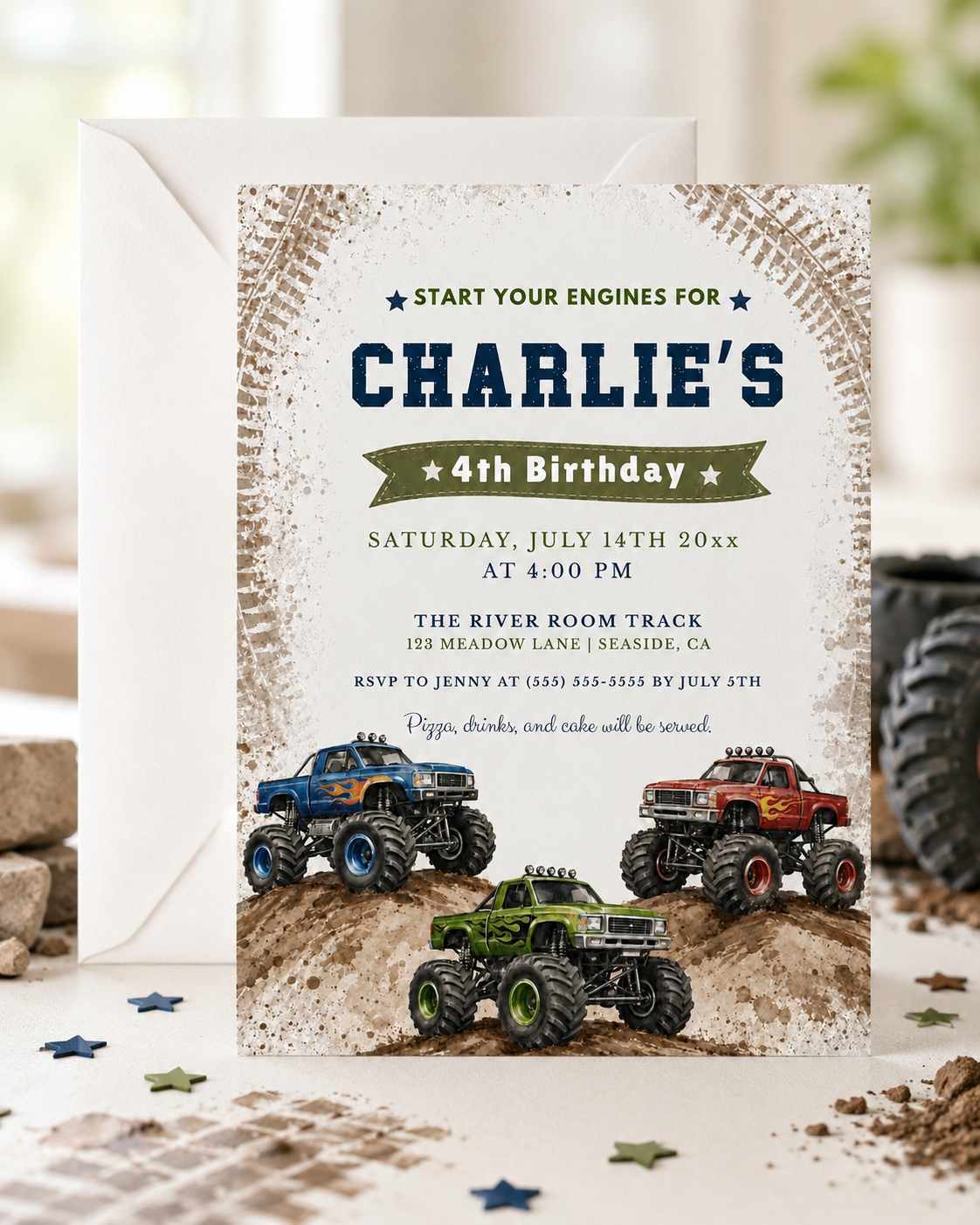 Monster truck birthday invitation featuring blue, red and green trucks racing over muddy hills with tire-track details.
