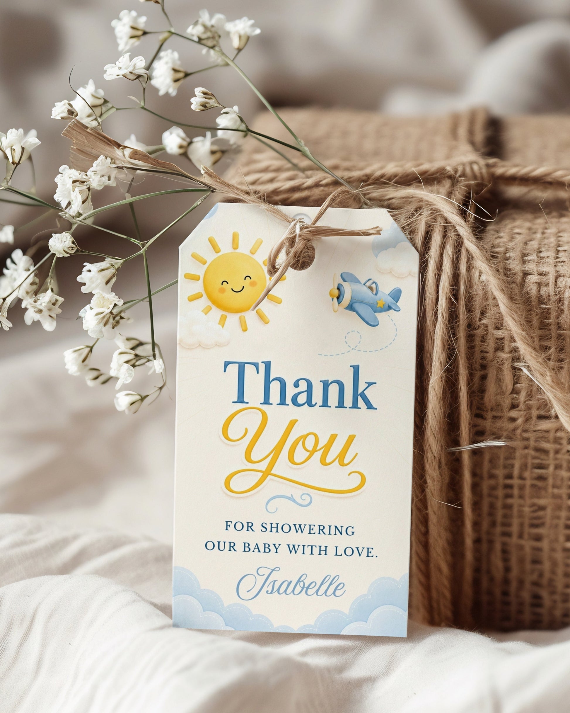 Editable here comes the son baby shower favor hang tag Canva template with smiling sun, blue toy airplane, fluffy clouds, and bold navy and golden script typography on a warm cream background