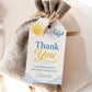 Editable here comes the son baby shower favor hang tag Canva template with smiling sun, blue toy airplane, fluffy clouds, and bold navy and golden script typography on a warm cream background