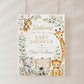 Editable safari baby shower welcome sign Canva template with watercolour monkey, giraffe, elephant, lion cub, and zebra surrounded by eucalyptus and tropical leaves with gold accents on a white background