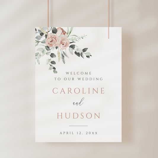 Blush floral and eucalyptus greenery wedding welcome sign template with rose gold spaced lettering on cream background, editable in Canva