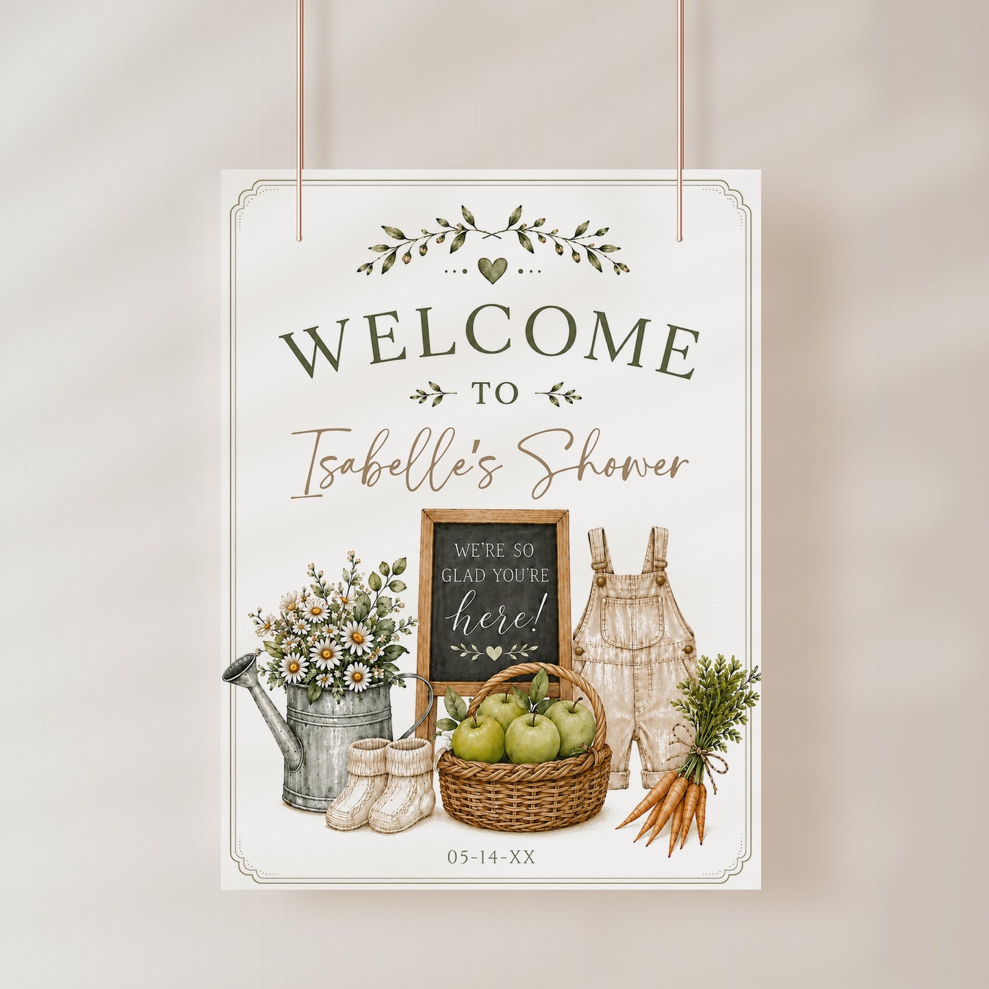 Homegrown baby shower welcome sign with a watering can, green apples, and baby overalls in sage green and neutral