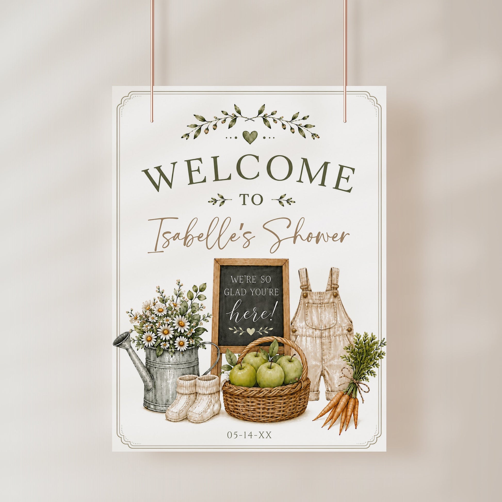 Homegrown baby shower welcome sign with a watering can, green apples, and baby overalls in sage green and neutral
