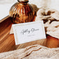 Minimalist wedding place card template with gold double frame border and elegant calligraphy script, editable in Canva
