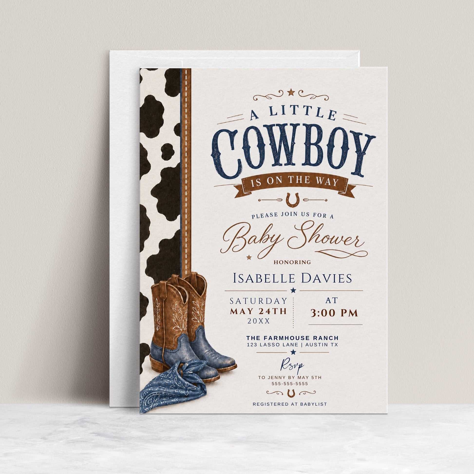 Editable cowboy baby shower invitation Canva template with cowhide side panel, leather cowboy boots, baby denim boots, bandana, horseshoe accent, and bold navy and brown distressed typography on a cream background