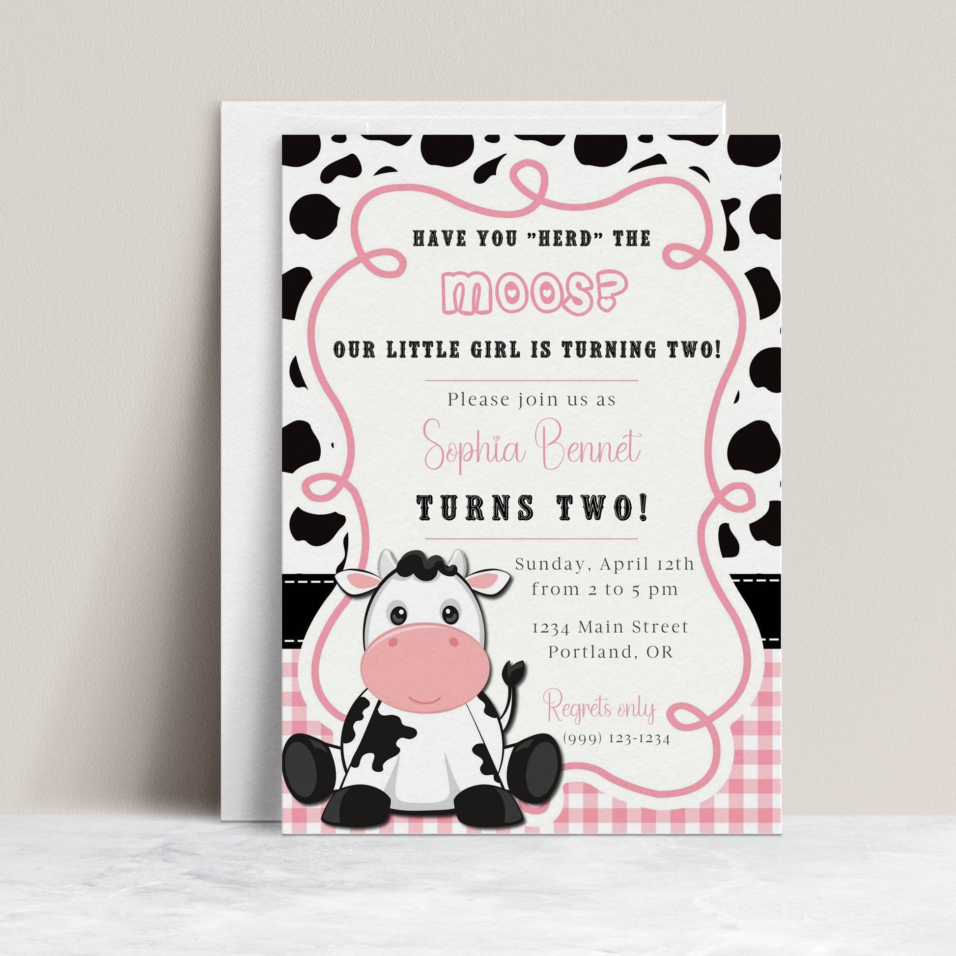 Cow print girl birthday invitation with a cartoon cow, cow spots, and pink gingham in black, white, and pink