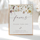 Wildflower baby shower favors sign template with watercolor meadow flowers in yellow, purple, and cream with calligraphy script, editable in Canva
