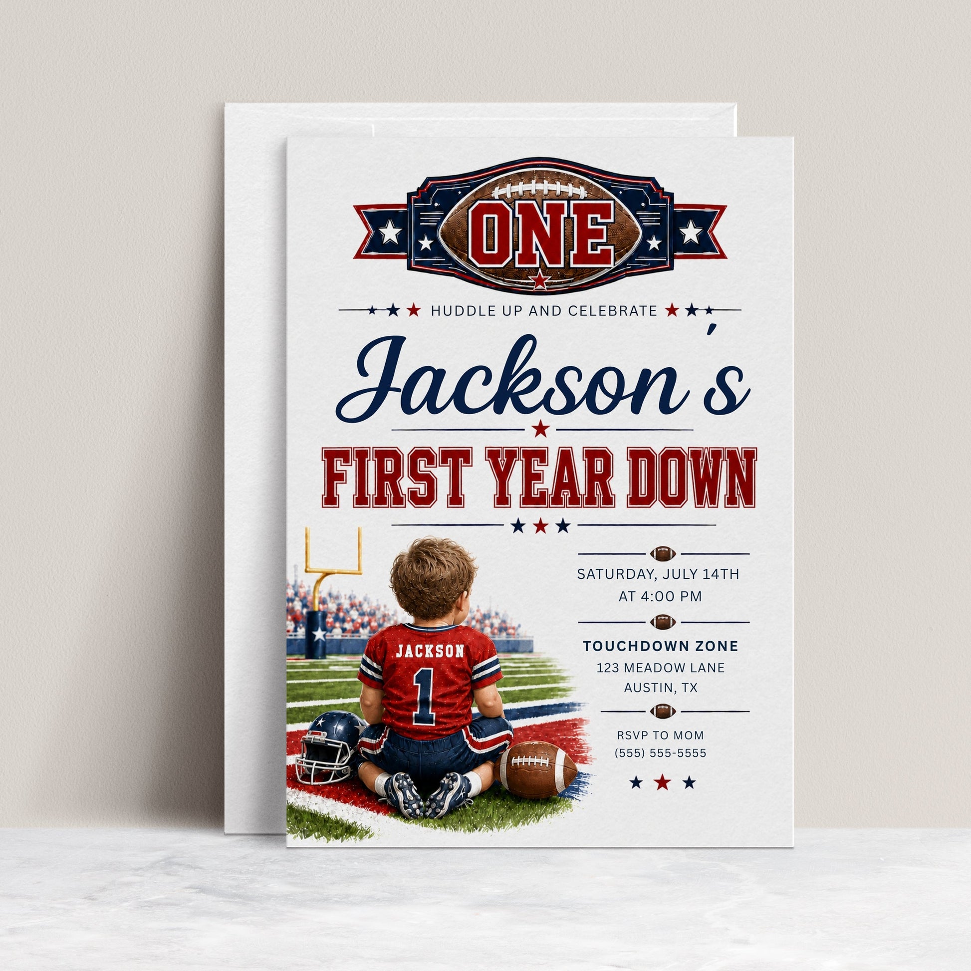 First Year Down first birthday invitation with little football player, stadium field, helmet, football, and red navy sports birthday party details