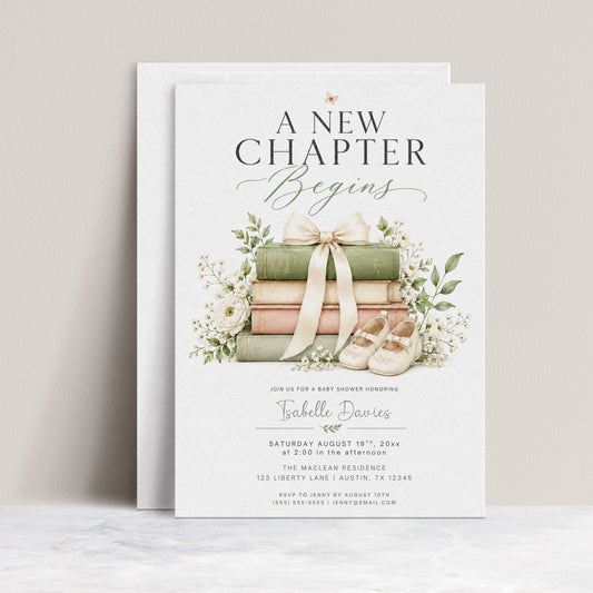 Editable a new chapter baby shower invitation Canva template with stacked vintage hardcover books tied with cream bow, baby shoes, white ranunculus, baby's breath, and botanical greenery on a white background