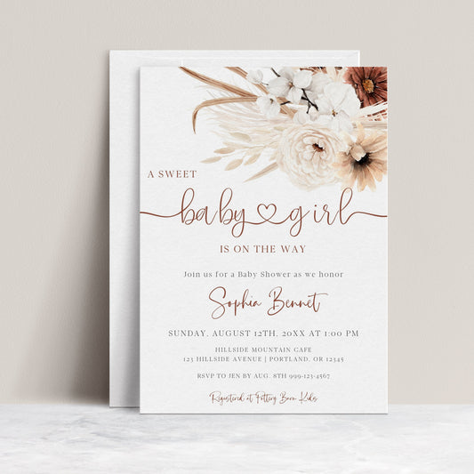 Boho brown floral baby girl shower invitation template with pampas grass, white orchids, and terracotta florals with rust calligraphy script, editable in Canva