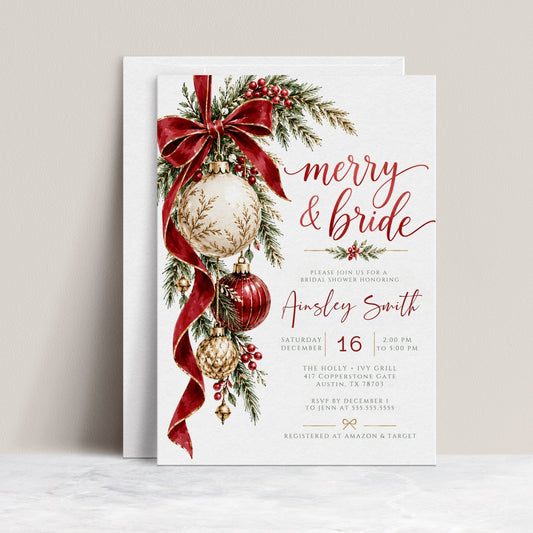 Christmas bridal shower invitation with Merry and Bride lettering, a flowing red bow, hanging ivory, red, and gold ornaments, evergreen branches, berries, and gold bells