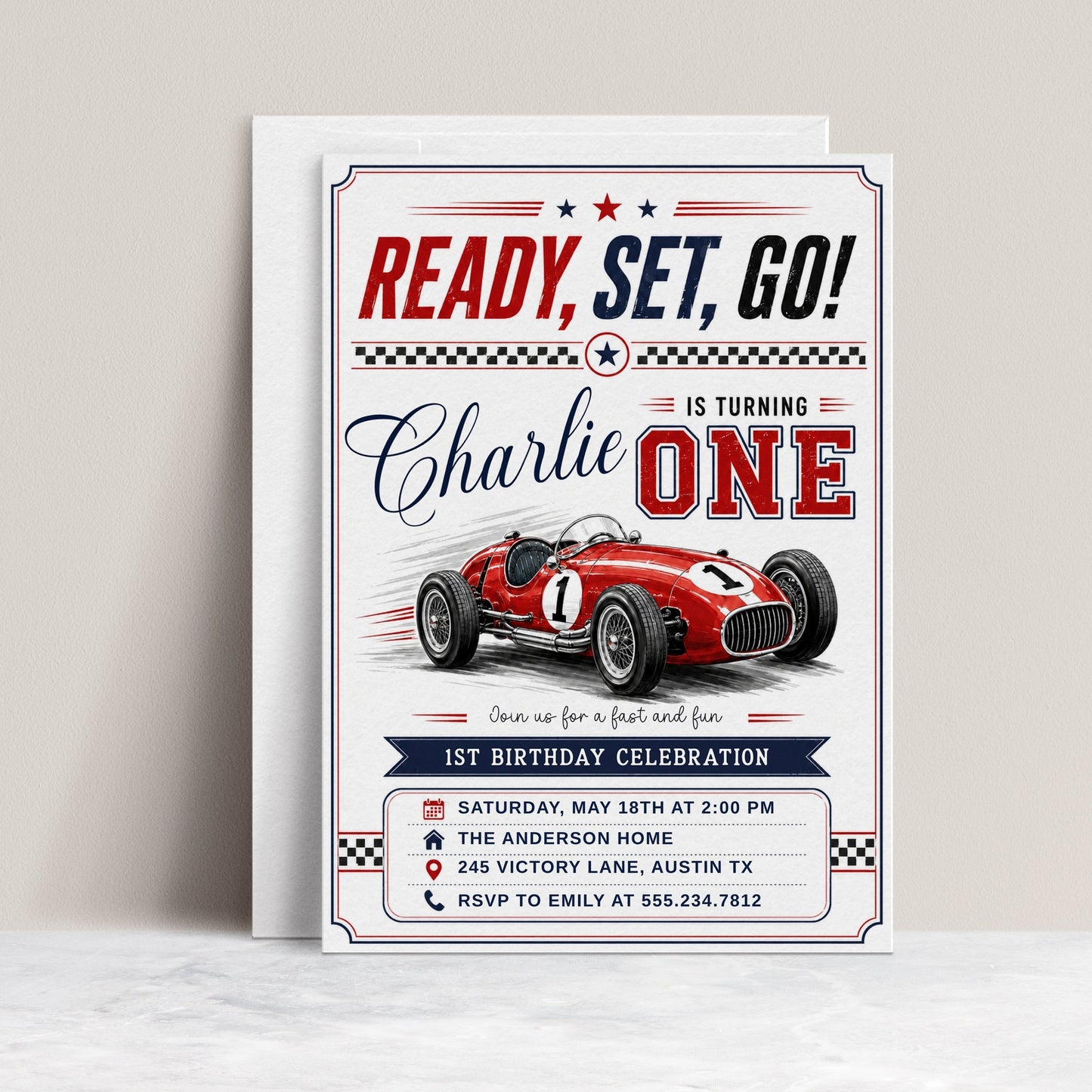 Race car first birthday invitation with red vintage race car, checkered flags, varsity ONE lettering, racing stripes, stars, and bold boys 1st birthday details
