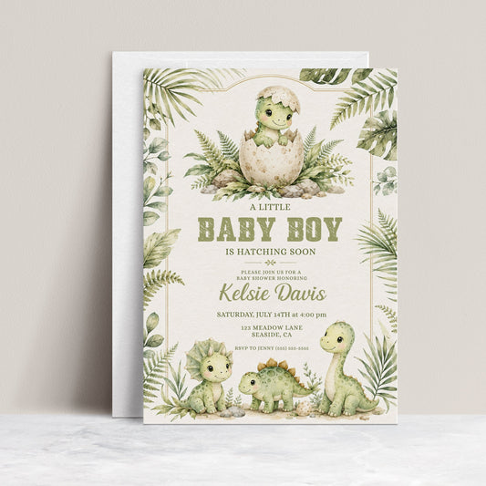 Baby boy dinosaur baby shower invitation with watercolor baby dinosaurs, hatching egg, tropical leaves, ferns, greenery, rocks, and soft sage green details