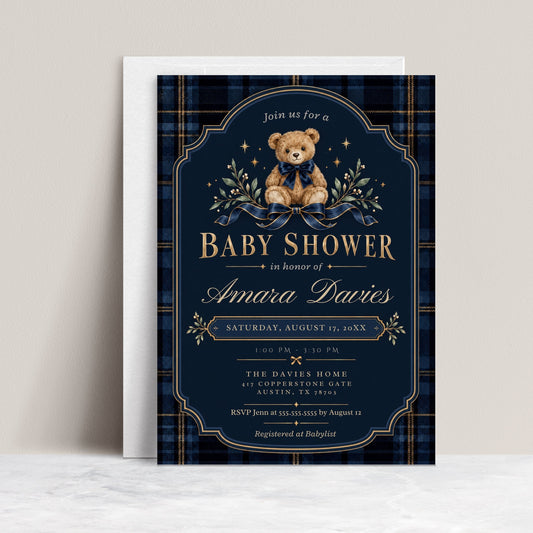 Teddy bear baby shower invitation with a brown bear wearing a navy bow, blue plaid border, gold lettering, stars, and greenery on a dark navy background