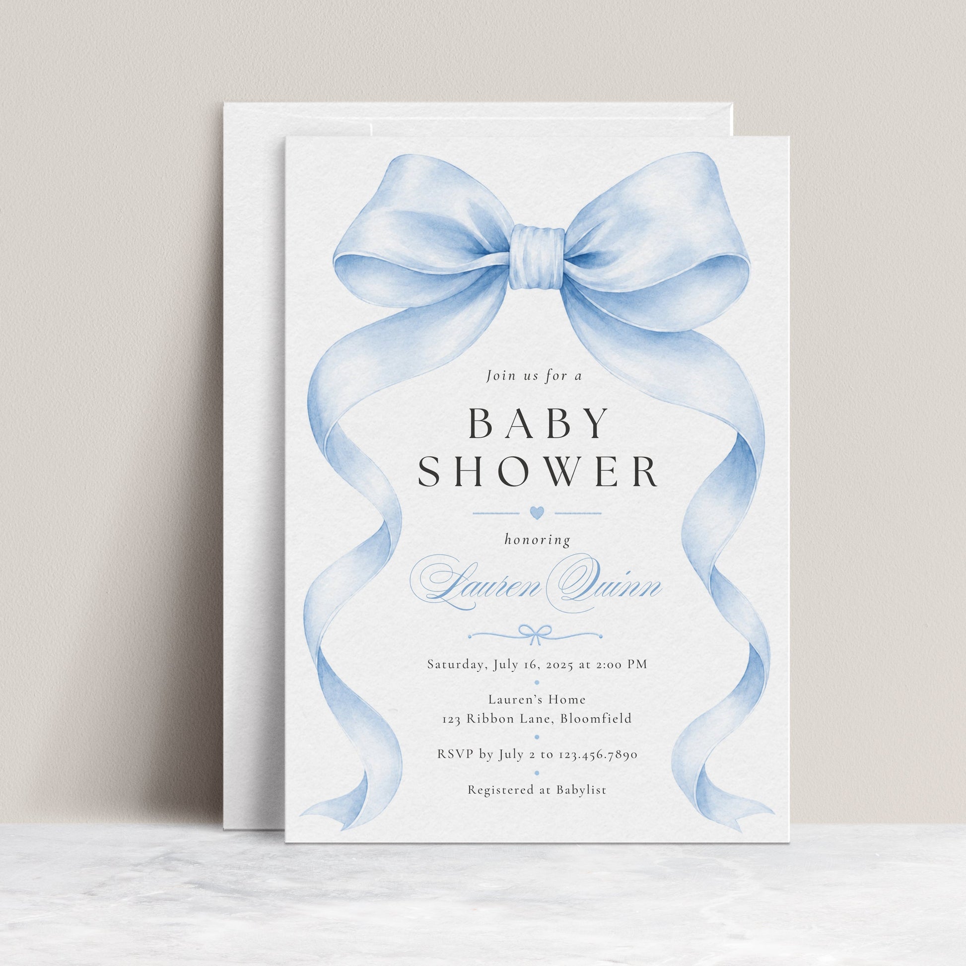 Editable blue bow baby boy shower invitation Canva template with oversized watercolour powder blue bow and flowing ribbon tails, bold spaced serif typography, and blue calligraphy script on a white background