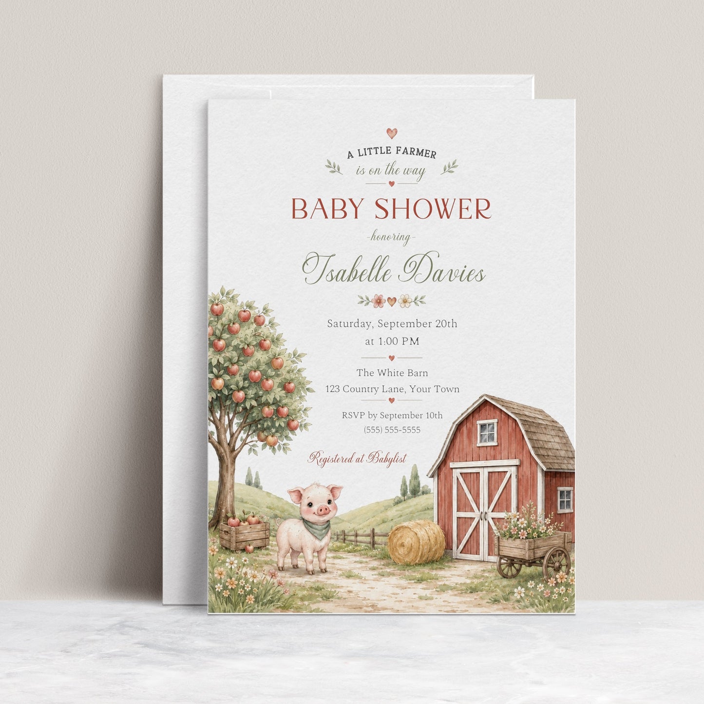 Little farm baby shower invitation with red barn, apple tree, piglet, hay bale, flower cart, rolling hills, fence, wildflowers, and soft farmhouse details
