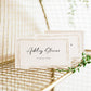 Minimalist wedding place card template with gold double frame border and elegant calligraphy script, editable in Canva