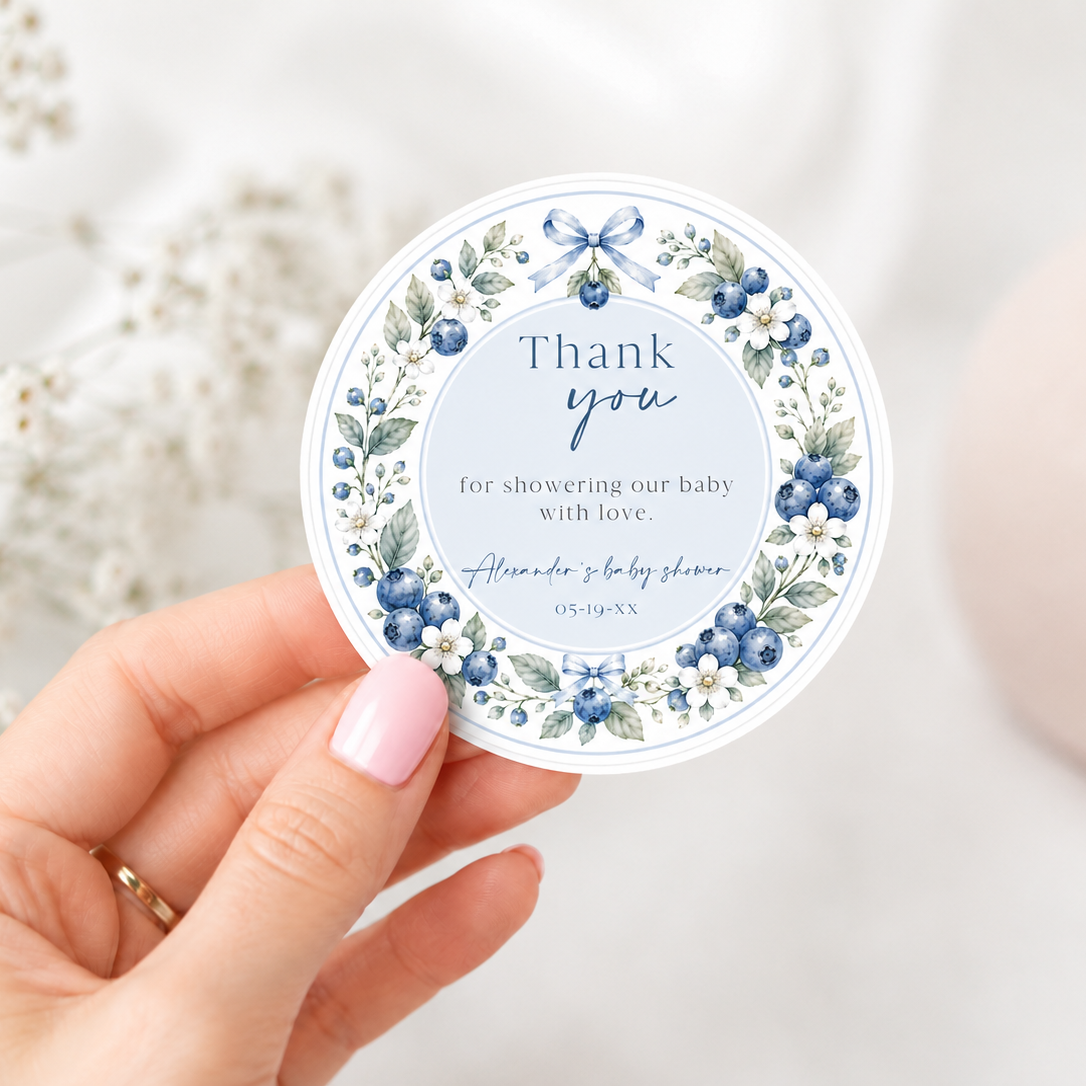 Editable blueberry baby shower round thank you sticker Canva template with watercolour blueberry wreath, white blossoms, blue ribbon bows, and script typography on a soft blue background